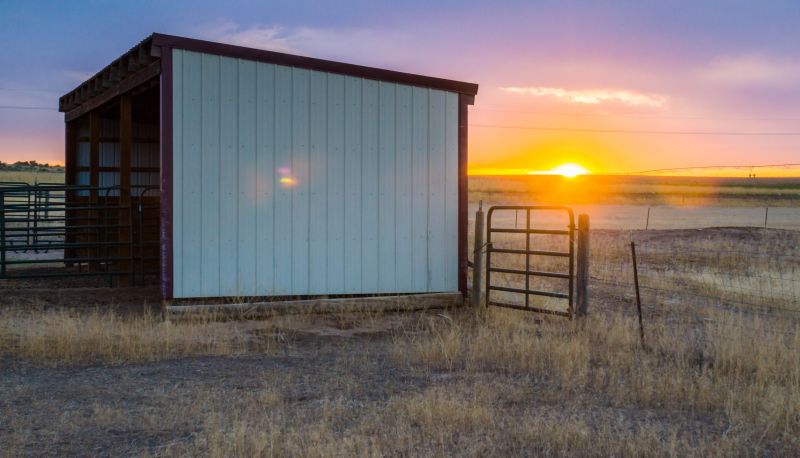 Painted Pole Barns in a Field